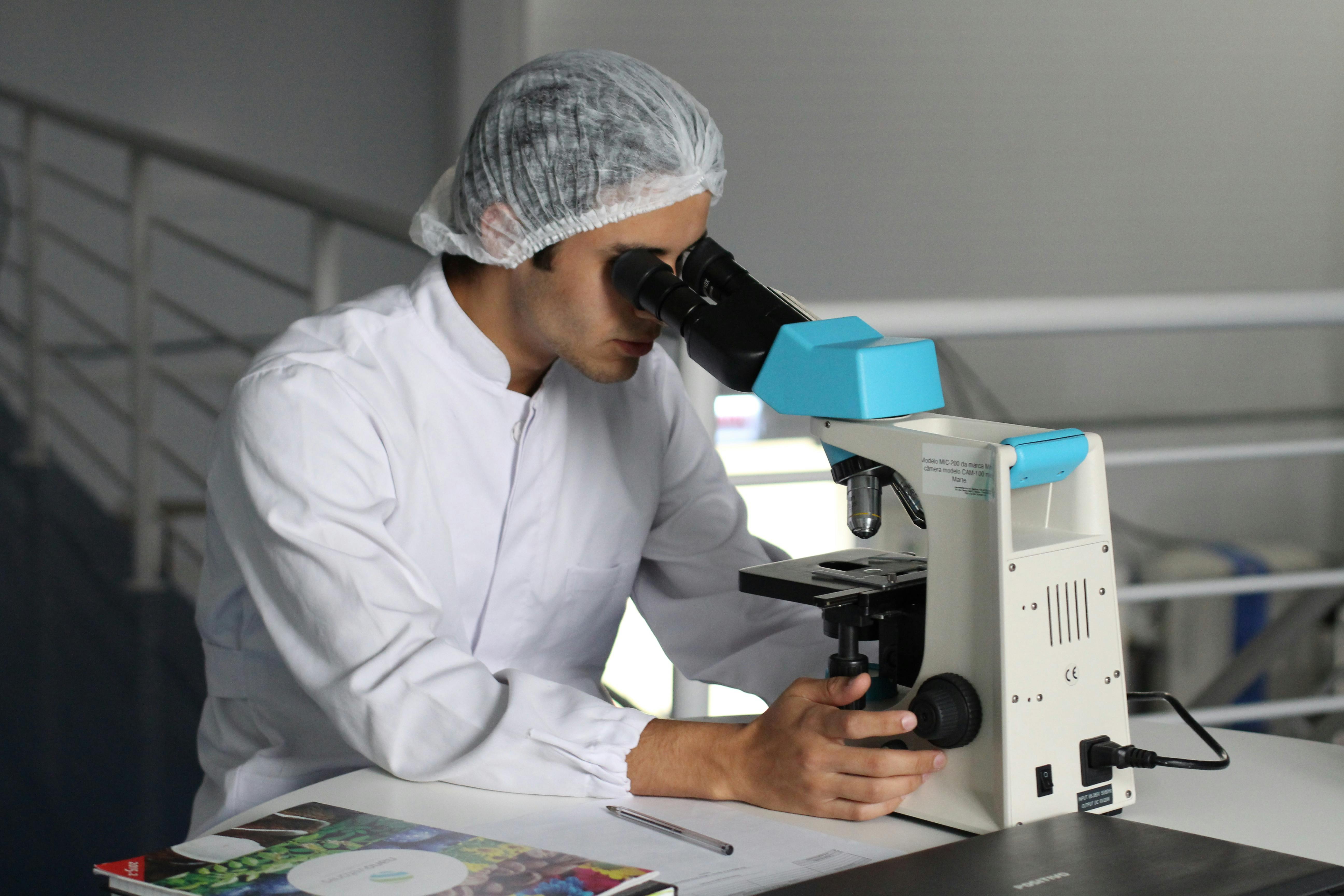A scientist using a microscope to study magic mushrooms