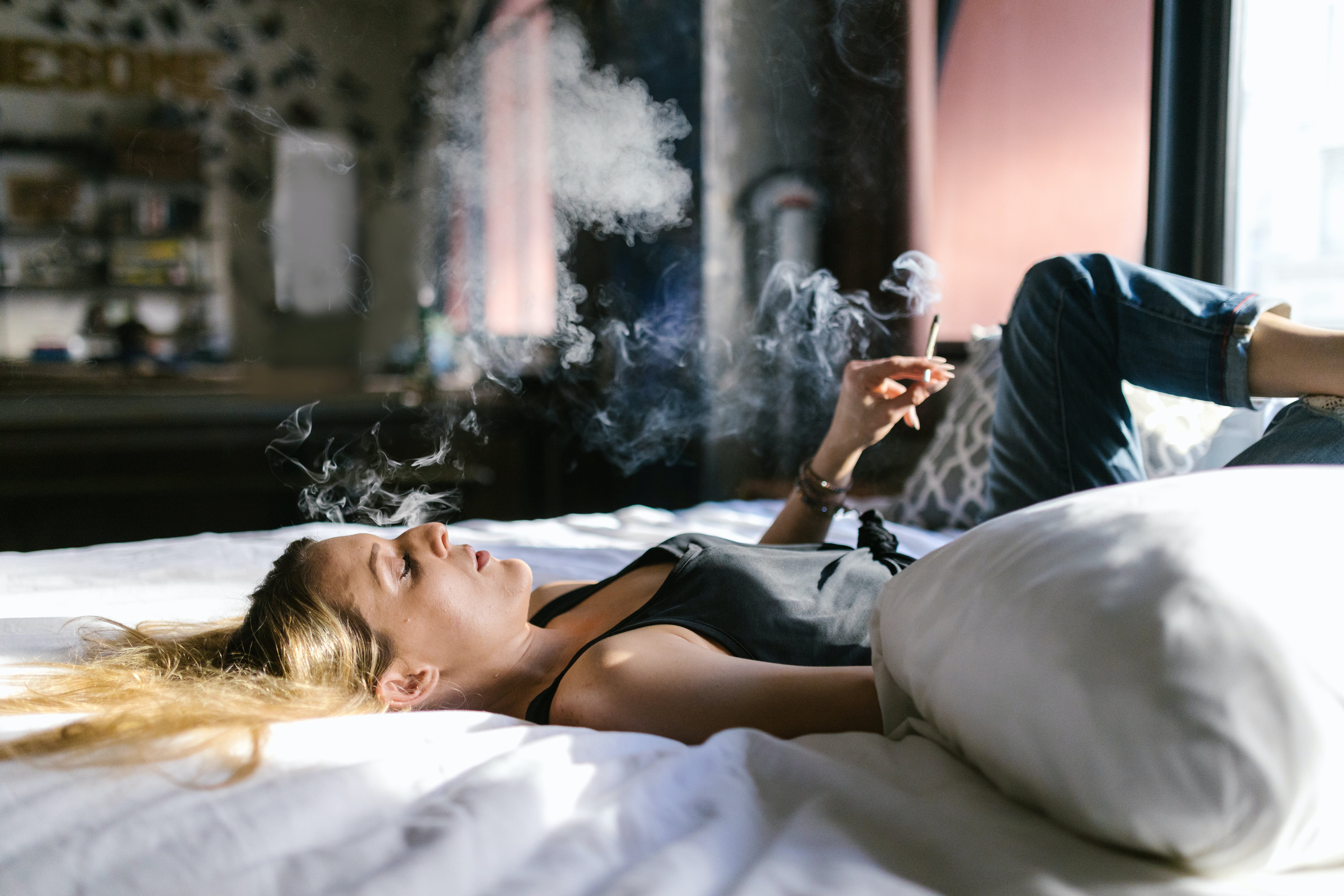 Woman relaxing while smoking THC